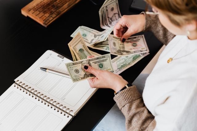picture of person counting money for TMS