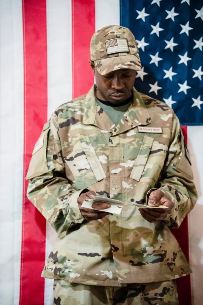 Veteran opening a letter in front of an American flag